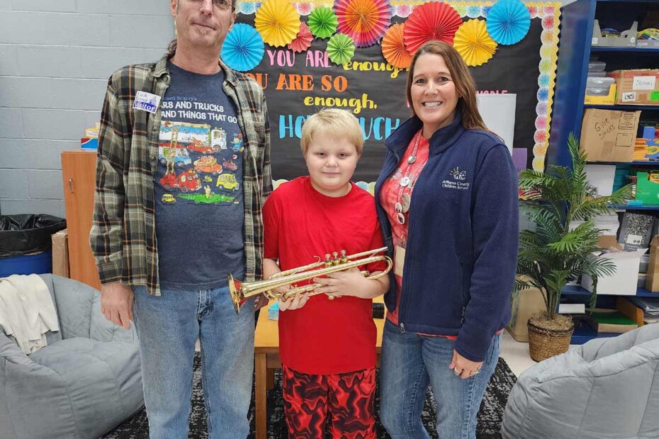 kid receiving a trumpet gift